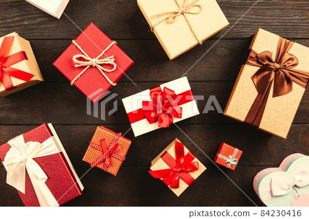 Christmas background with gift boxes on wooden table 84230416