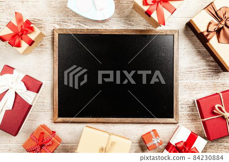 Christmas background with gift boxes on wooden table 84230884