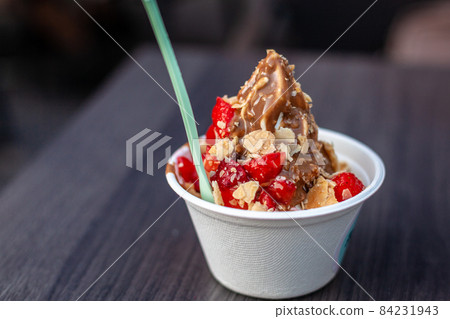 frozen yogurt with strawberries and chocolate sauce frozen yogurt with strawberries and chocolate sauce 84231943