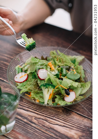 Image of women eating green salad, vegan, vegetarian, and vegetarian 84231953