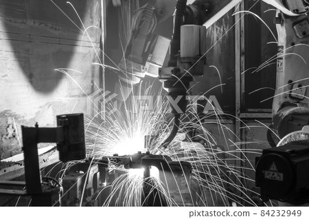 robots welding in a car factory, black&white 84232949