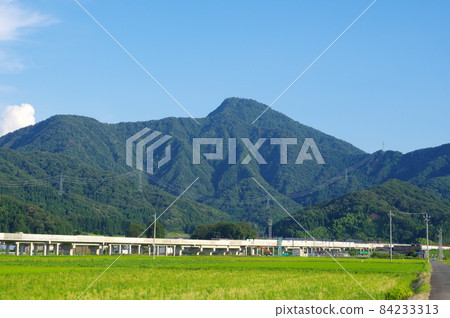 Hokuriku Shinkansen at the foot of Mt. Hino, Echizen City, Fukui Prefecture 84233313