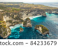 Aerial shot at sea with turquoise water and rocks. Atuh beach, Nusa Penida, Bali, Indonesia. 84233679