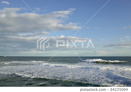 Blue sky, dim clouds and a little rough sea in the afternoon of Indian summer in early winter 84235004