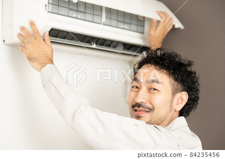 Image of smiling house cleaning to clean the air conditioner There is a copy space Image of smiling house cleaning to clean the air conditioner There is a copy space 84235456