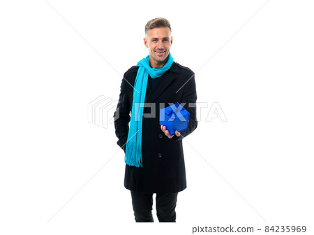 Happy handsome man in overcoat with long scarf give present gift box isolated on white, giving 84235969