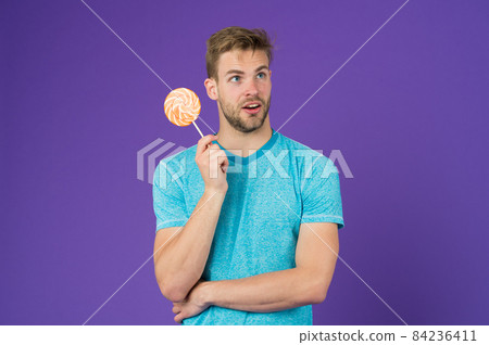 Cheat meal concept. Sugar harmful for health. Guy hold 84236411