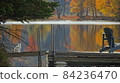 Cats and autumn leaves lake and chairs 84236470