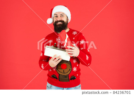 happy new year. merry christmas. happy bearded man in santa claus hat. 84236701