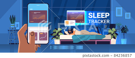 woman sleeping in bed with electronic smart watch app tracker on hand quality and quantity sleep control concept woman sleeping in bed with electronic smart watch app tracker on hand quality and quantity sleep control concept 84236857