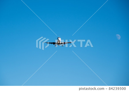 Airplane just before landing against the background of the moon 84239300