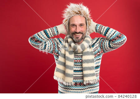A winter ensemble protects him from cold. Mature 84240128