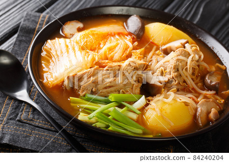 Gamja-tang or pork backbone stew is a spicy Korean soup close up in the bowl. Horizontal Gamja-tang or pork backbone stew is a spicy Korean soup close up in the bowl. Horizontal 84240204