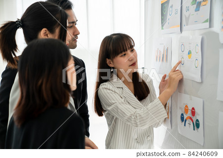 Business people proficiently discuss work project while sitting in circle 84240609