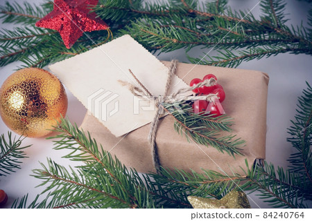 Vintage toned photo of craft gift box and greeting card with space for text. Christmas, New Year holiday background 84240764