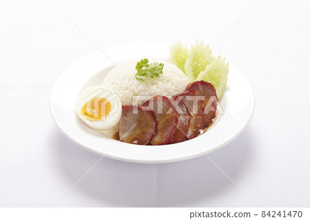 BBQ Pork and Crispy Pork on rice with sauce on white background. 84241470