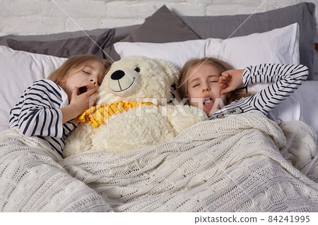 The image of two little sisters awakes in the morning The image of two little sisters awakes in the morning 84241995