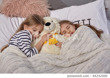 The image of two little sisters awakes in the morning The image of two little sisters awakes in the morning 84242000
