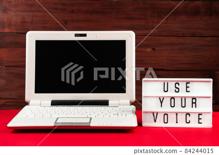 Online voting. Laptop and notepad on a red background. Election concept, place for text. Online voting. Laptop and notepad on a red background. Election concept, place for text. 84244015