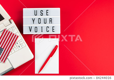 Online voting. Laptop and notepad on a red background. Election concept, place for text. Online voting. Laptop and notepad on a red background. Election concept, place for text. 84244016
