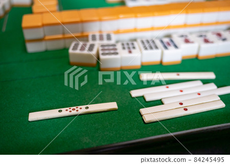 Mahjong tiles on the electric mahjong table 84245495