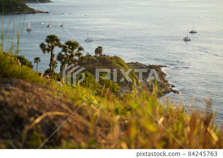 Tourists at Phromthep cape viewpoint at the south of Phuket Island, Thailand. Tropical paradise in Thailand. Phuket is a popular destination famous for tourists 84245763