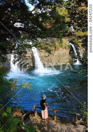 A female figure looking at the beautiful Goryu Waterfall in a valley in Shizuoka Prefecture A female figure looking at the beautiful Goryu Waterfall in a valley in Shizuoka Prefecture 84247220