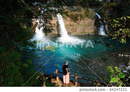 A female figure looking at the beautiful Goryu Waterfall in a valley in Shizuoka Prefecture A female figure looking at the beautiful Goryu Waterfall in a valley in Shizuoka Prefecture 84247221
