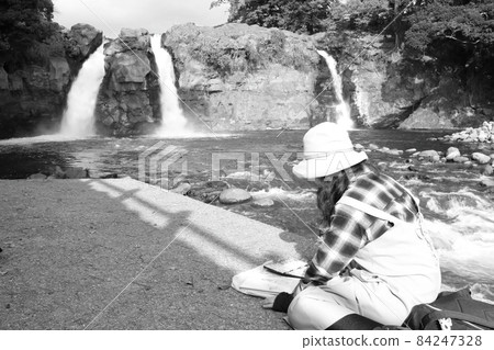A woman sketching a beautiful Goryu waterfall in a valley in Shizuoka prefecture A woman sketching a beautiful Goryu waterfall in a valley in Shizuoka prefecture 84247328