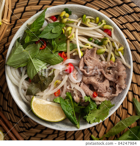 Delicious vietnamese beef noodles pho with ingredients. 84247984