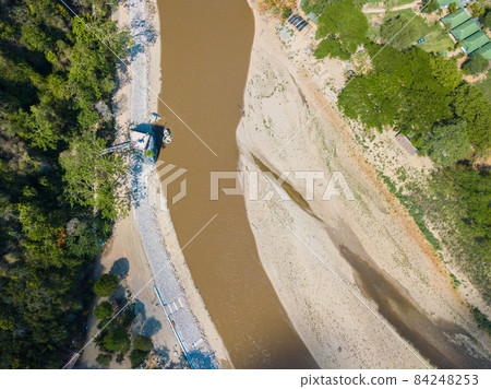 Aerial view of dry river of Kok river in hot season nearly Chiang Rai beach, a river bank with rocky shores view. Mae Khok River is that runs through the city of Chiang Rai. Aerial view of dry river of Kok river in hot season nearly Chiang Rai beach, a river bank with rocky shores view. Mae Khok River is that runs through the city of Chiang Rai. 84248253