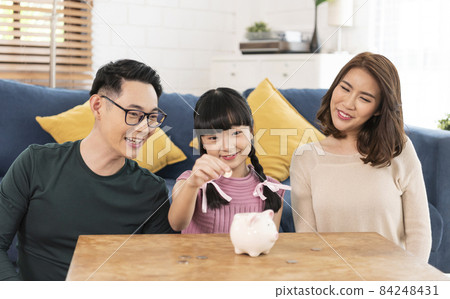 Happy Asian family saving money in piggy bank pig. investment for future concept. 84248431