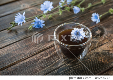 Chicory drink in thermo glass cup on brown wooden table with copy space Chicory drink in thermo glass cup on brown wooden table with copy space 84248778