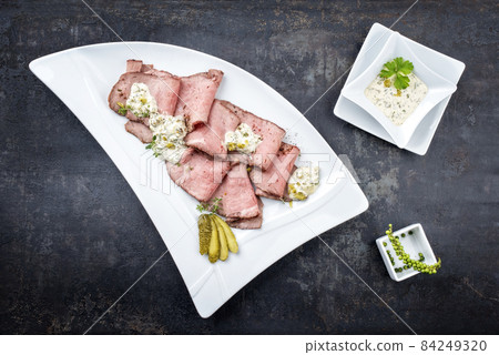 Traditional lunch meat with sliced cold cuts roast beef and remoulade Traditional lunch meat with sliced cold cuts roast beef and remoulade 84249320