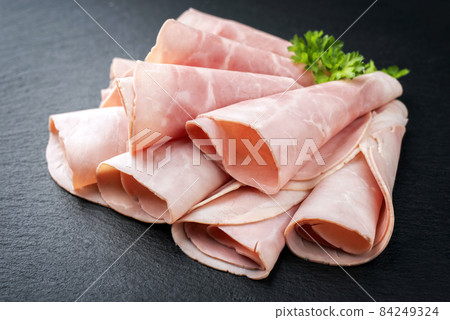 Traditional German boiled ham as curled slices  84249324