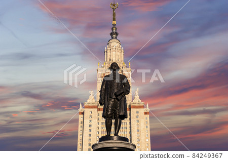 View of the monument to Mikhail Vasilyevich Lomonosov (sculptor N. V. Tomsky and architect L. V. Rudnev, 1953)from building of Moscow State University (MSU), on the background of the sky, Russia 84249367