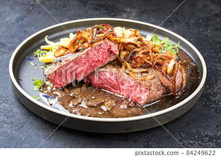 dry aged sliced roast beef with fried onion rings and Swabian spaetzle dry aged sliced roast beef with fried onion rings and Swabian spaetzle 84249622