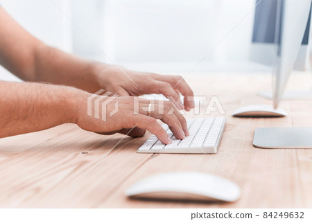 close up. young man typing on computer keyboard 84249632
