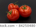 Tomato on black background, isolated red vegetable 84250480