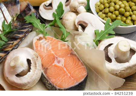 Healthy food, foods rich in vitamin D, omega 3 and protein, sea red salmon, smoked mackerel, mushrooms, champignons, canned green peas and arugula. Cooking recipe for the keto diet 84251239