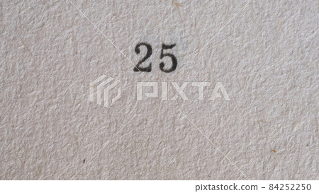 The number 25 printed on a piece of paper. Paper texture. 84252250