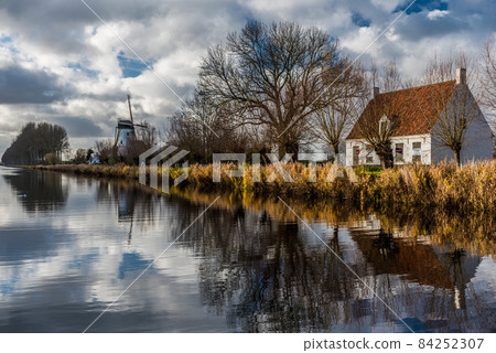 Damme, West Flemish Region, Belgium - 11 15 2017: The canal of the Damse vaart with late autumn nature reflecting in the water Damme, West Flemish Region, Belgium - 11 15 2017: The canal of the Damse vaart with late autumn nature reflecting in the water 84252307