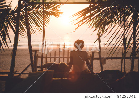 Silhouette of a person relaxing in a cafe and sunset on the main beach of Gokarna, Karnataka, India Silhouette of a person relaxing in a cafe and sunset on the main beach of Gokarna, Karnataka, India 84252341