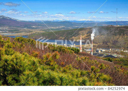 Mountain landscape with chimneys of a power plant Mountain landscape with chimneys of a power plant 84252974
