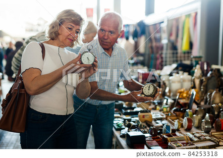 Loving mature couple buys alarm clock on flea market Loving mature couple buys alarm clock on flea market 84253318