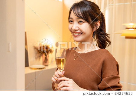 A woman drinking champagne A woman drinking champagne 84254633
