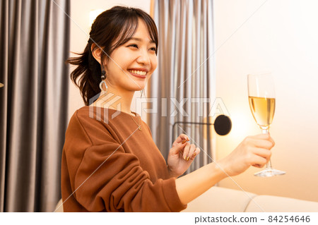 A woman drinking champagne 84254646