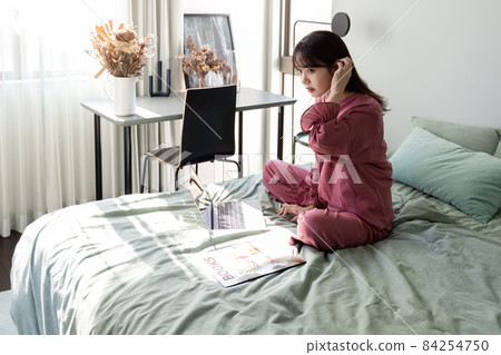 A woman in the bedroom A woman in the bedroom 84254750