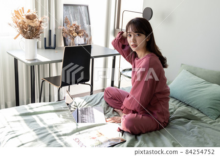 A woman in the bedroom A woman in the bedroom 84254752