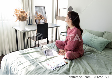A woman in the bedroom A woman in the bedroom 84254975